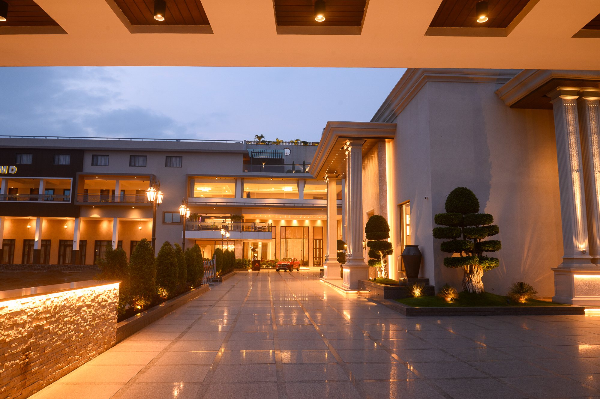 JMD Palace arrival court glowing at dusk